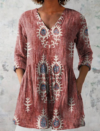 Red long-sleeve V-neck embroidered blouse with gathered waist and paisley-like folk motifs