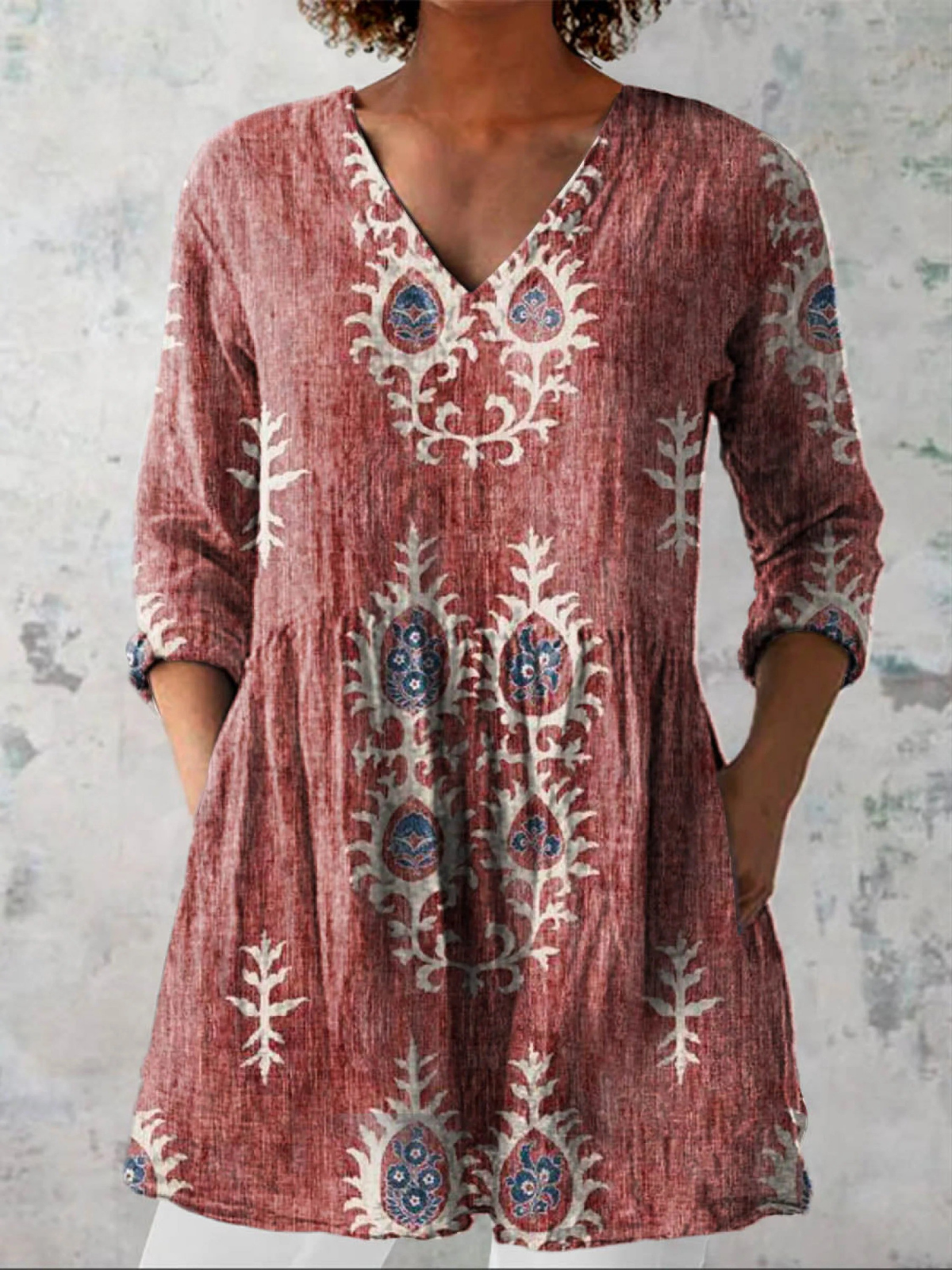 Red long-sleeve V-neck embroidered blouse with gathered waist and paisley-like folk motifs
