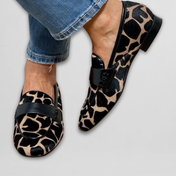 Animal-print loafer shoes with black strap detail and low heel