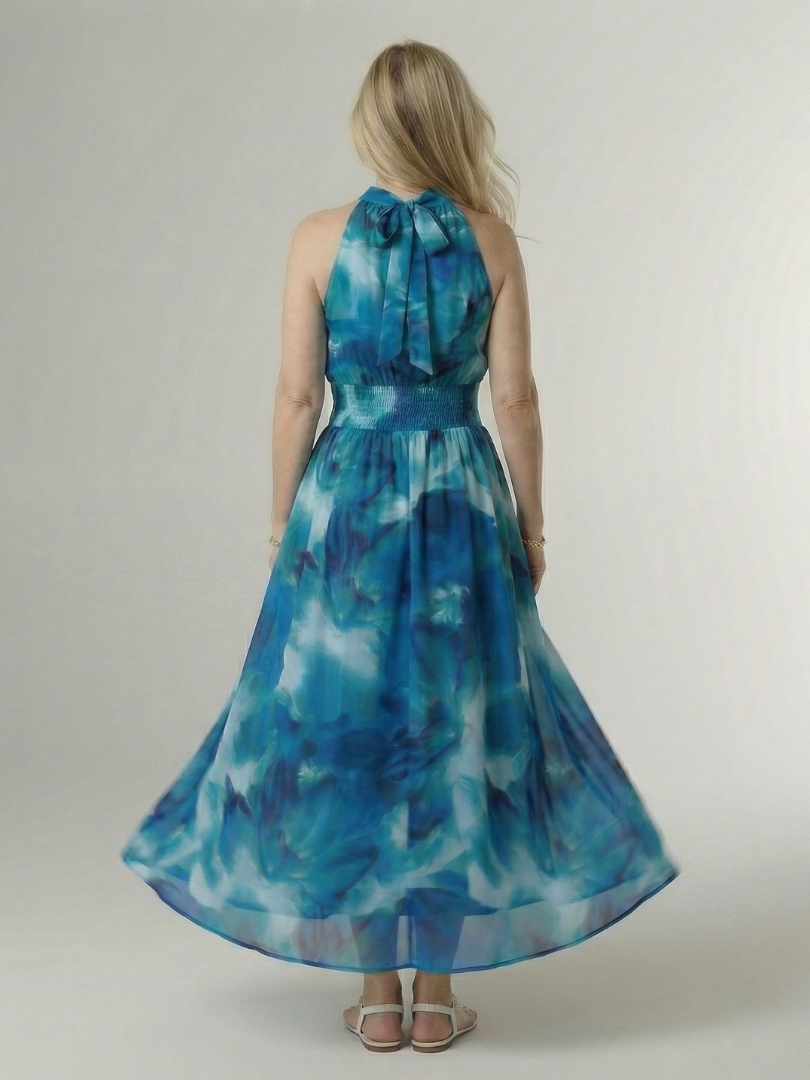 Blue tie-dye halter midi dress, back view with gathered neckline bow and smocked waist