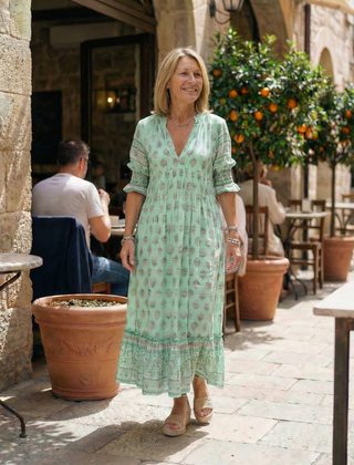 Green floral tiered midi dress with V-neck and short puff sleeves