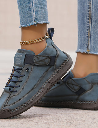 Orthopedic comfort sneaker in dark blue with lace-up and side strap detail.