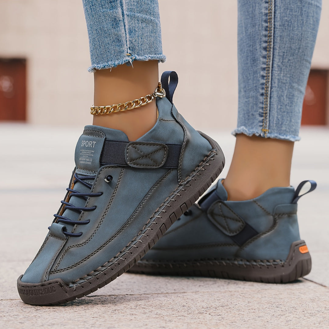 Orthopedic comfort sneaker in dark blue with lace-up and side strap detail.
