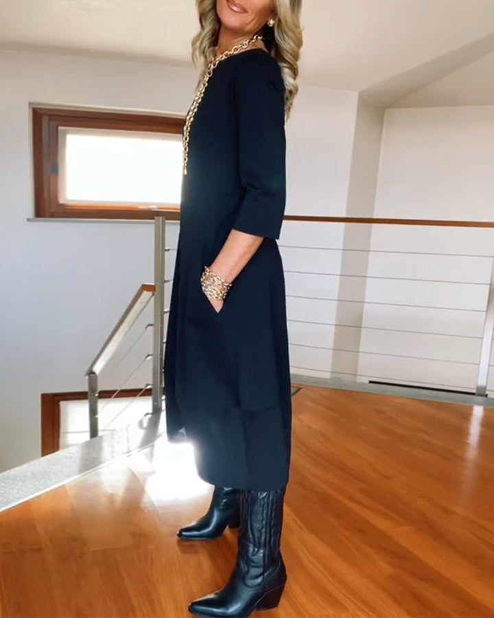 Nia casual elegance dress, dark color, side profile, midi length, three-quarter sleeves