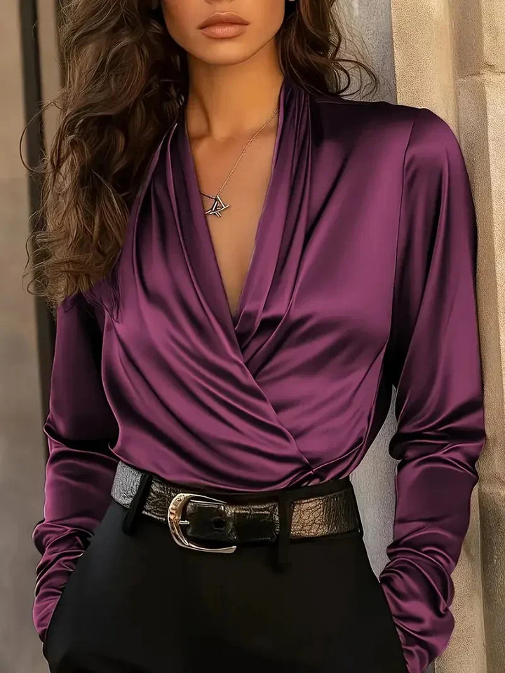 Purple satin V-neck wrap top with long sleeves and draped front