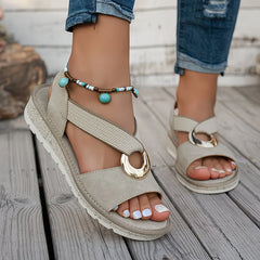 Beige flat sandals with oval metal buckle, beaded ankle strap and turquoise accents