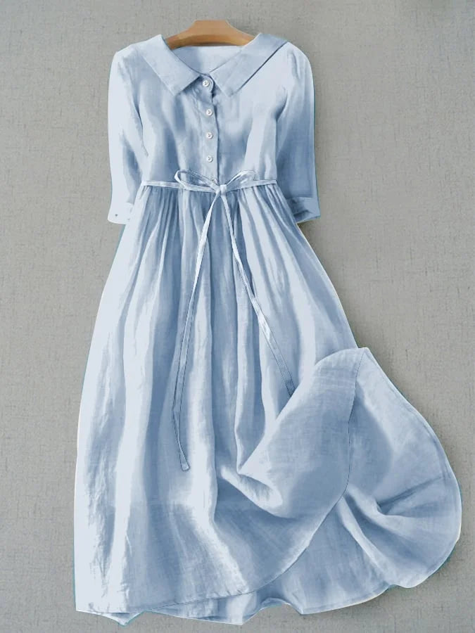 Light blue short-sleeve dress with button front and gathered waist, tied belt