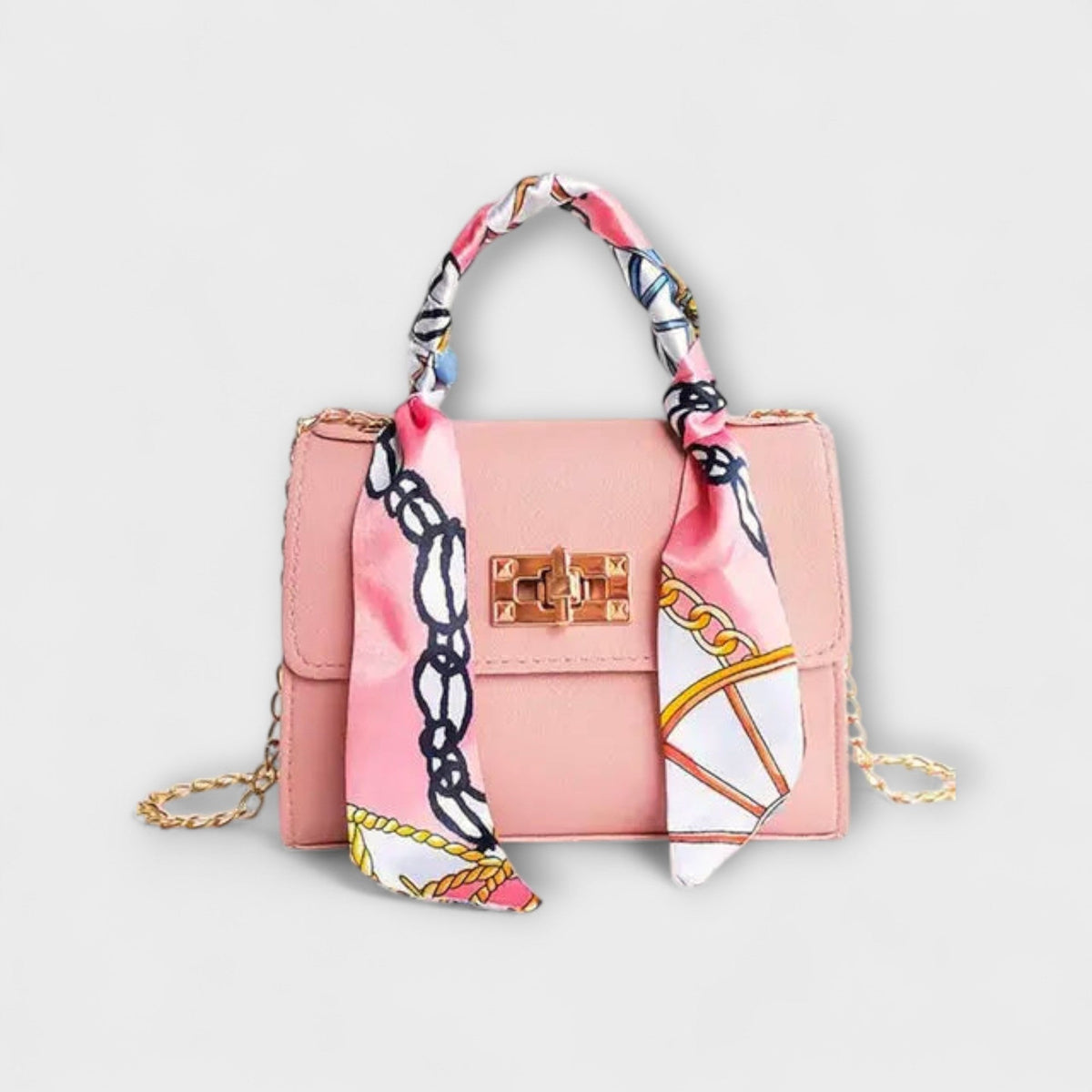 Pink handbag with gold clasp, chain strap, and multicolor patterned scarf