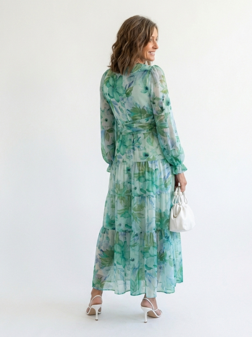 Green floral maxi dress with long sleeves and tiered ruffle skirt, side view
