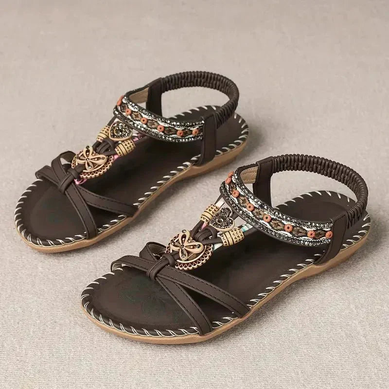 Dark brown boho flat sandals with wide straps and beaded trim, open-toe