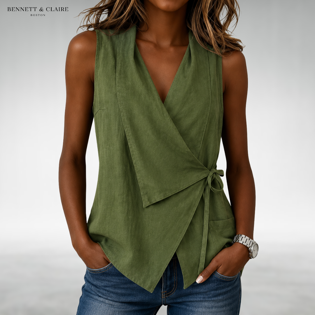 Green sleeveless wrap blouse with V-neck and side tie at waist.