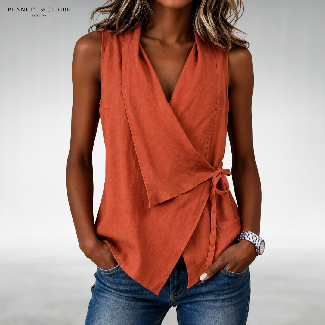 Orange sleeveless wrap blouse with V-neck and side tie at waist.