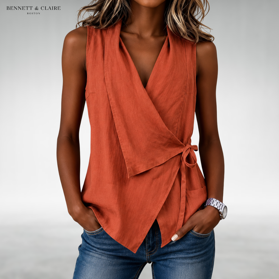 Orange sleeveless wrap blouse with V-neck and side tie at waist.