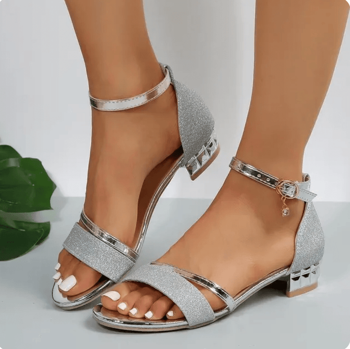 Elegant silver glitter heeled sandals with crisscross straps and ankle buckle
