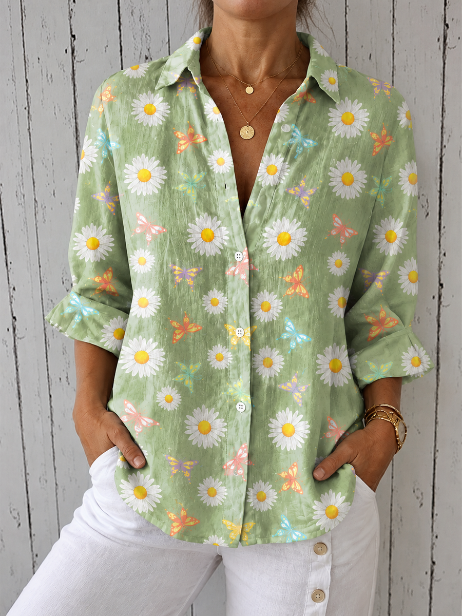 Green button-front blouse with daisy print, butterfly accents and V-neck