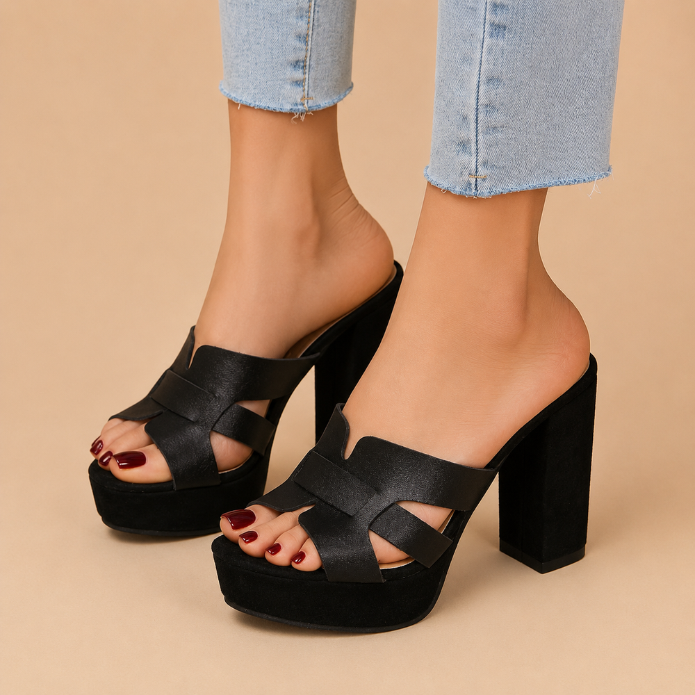 Black platform heeled slide sandals with cross straps and open toe