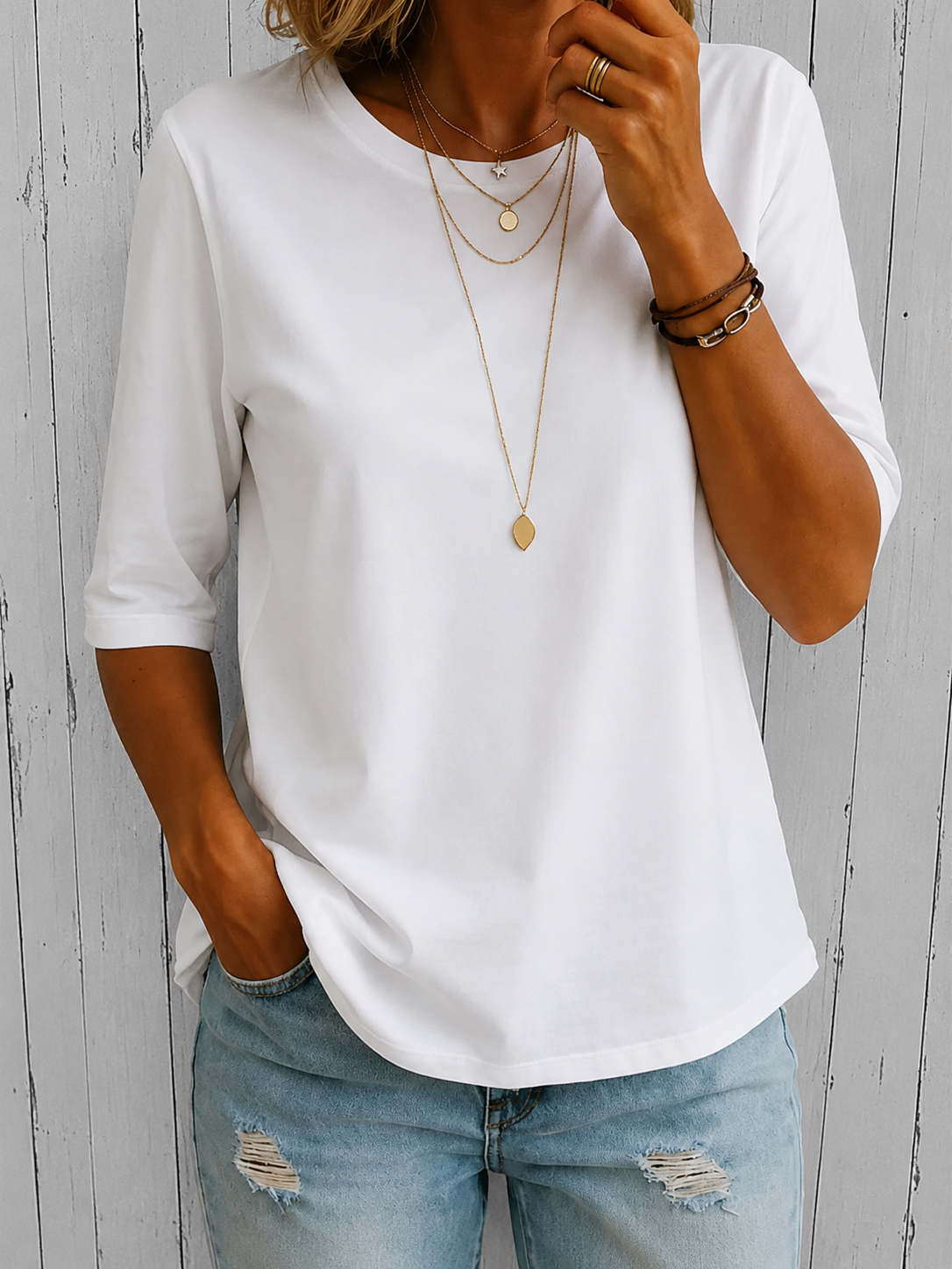 White crewneck comfort tee with 3/4 sleeves and draped fit