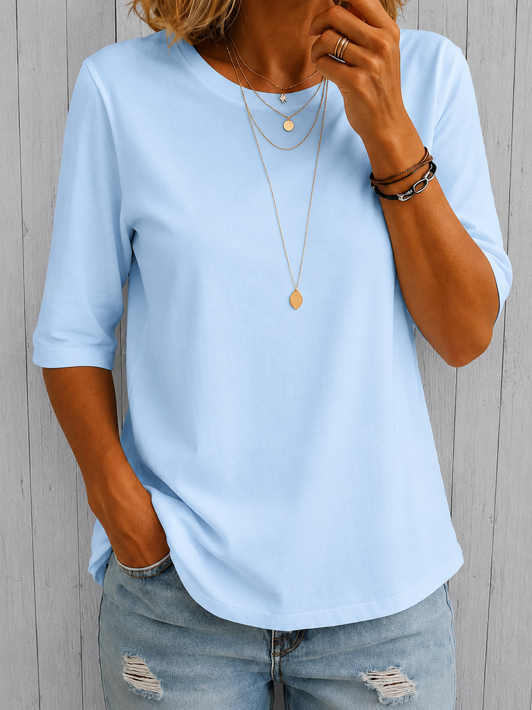 Light blue crewneck comfort tee with 3/4 sleeves and draped fit