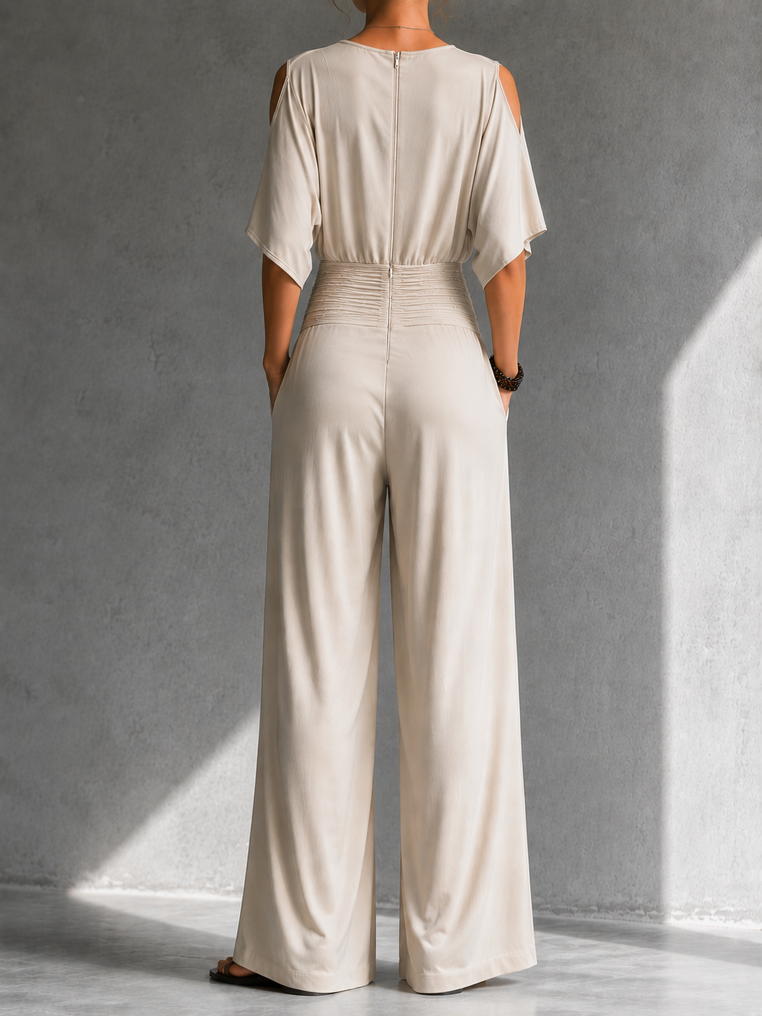 Cream sleeveless-back jumpsuit with back seam and wide-leg pants