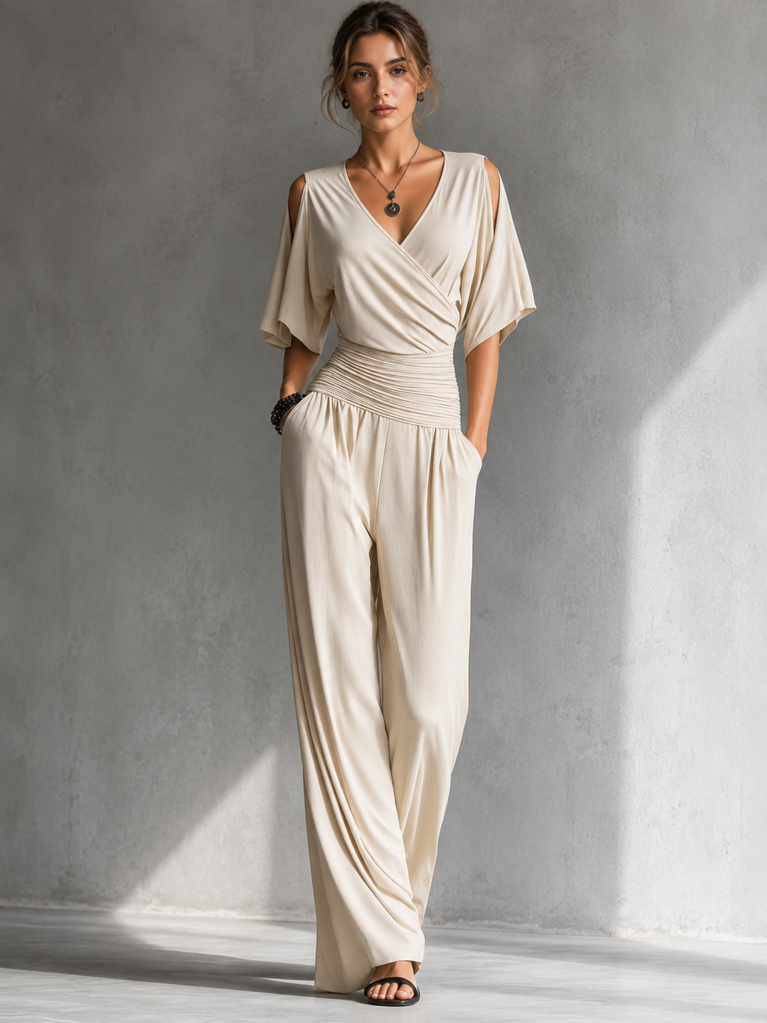 Cream wrap jumpsuit with V-neck, draped bodice, ruched waist, wide-leg pants
