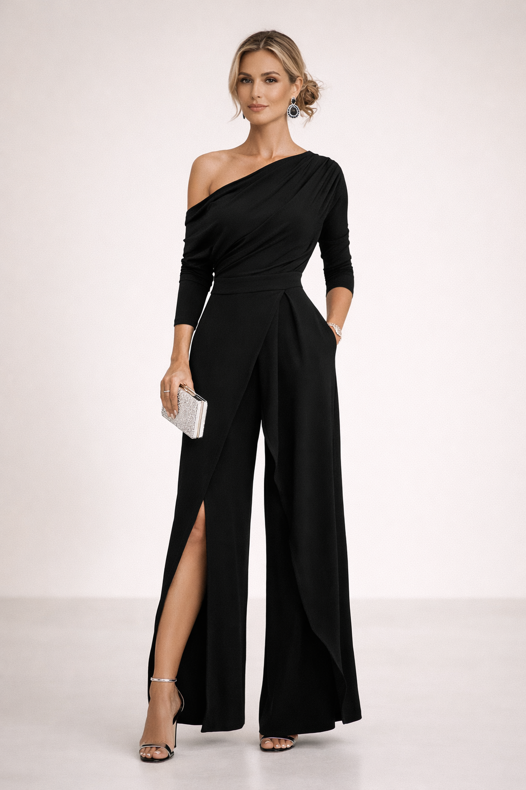 Black one-shoulder draped jumpsuit with long sleeves, fitted waist, and wide legs