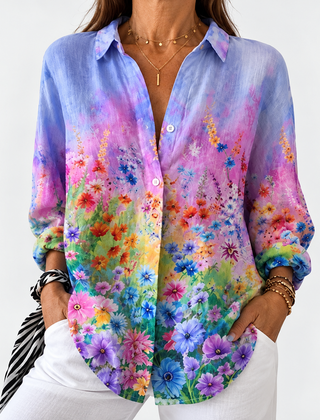 Floral button-up blouse with long sleeves, V-neck; multicolor blooms on blue ground