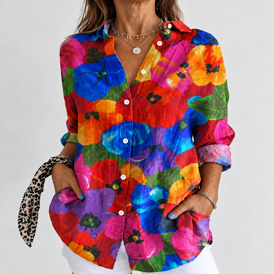 Colorful tropical-print button-up blouse with long sleeves and collar