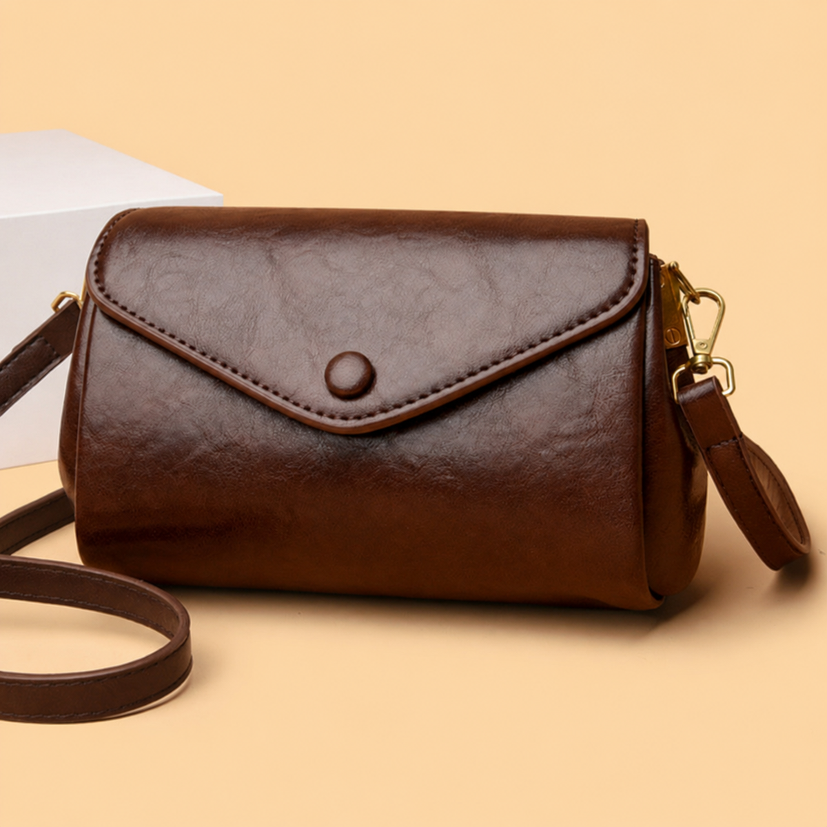 Dark brown classic crossbody bag with front flap, snap button, and crossbody strap
