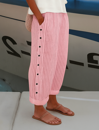 Pink-and-white vertical striped trousers with front buttons, wide leg