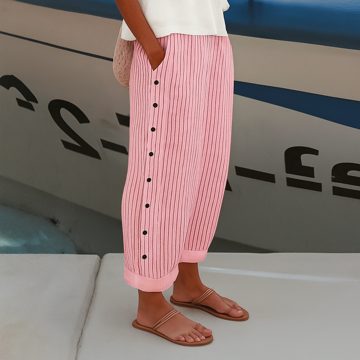 Pink-and-white vertical striped trousers with front buttons, wide leg