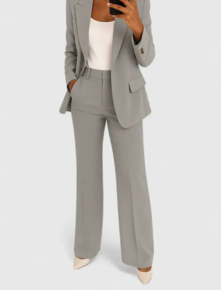 Gray two-piece blazer and trousers set with notched lapels and matching pants