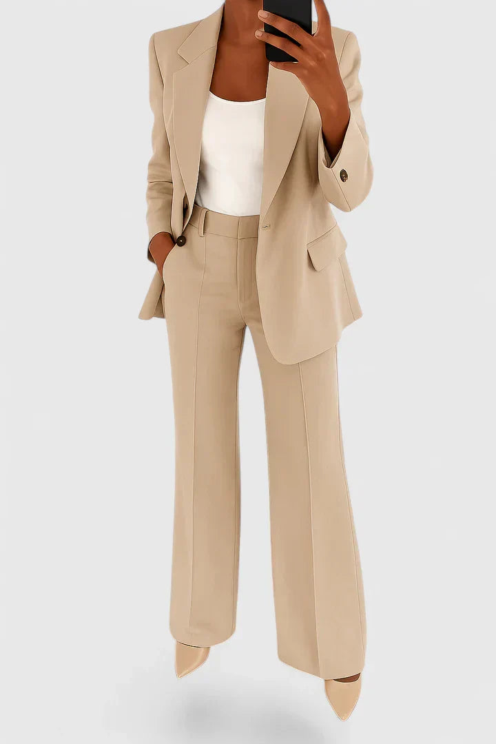 Beige two-piece blazer and trousers set with notched lapels and cuffed hems