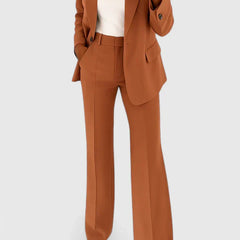 Rust brown two-piece blazer and trousers set with notched lapels and flap pockets