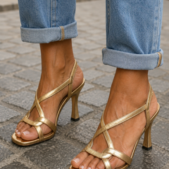 Gold strappy open-toe heeled sandals, side view with crisscross ankle strap