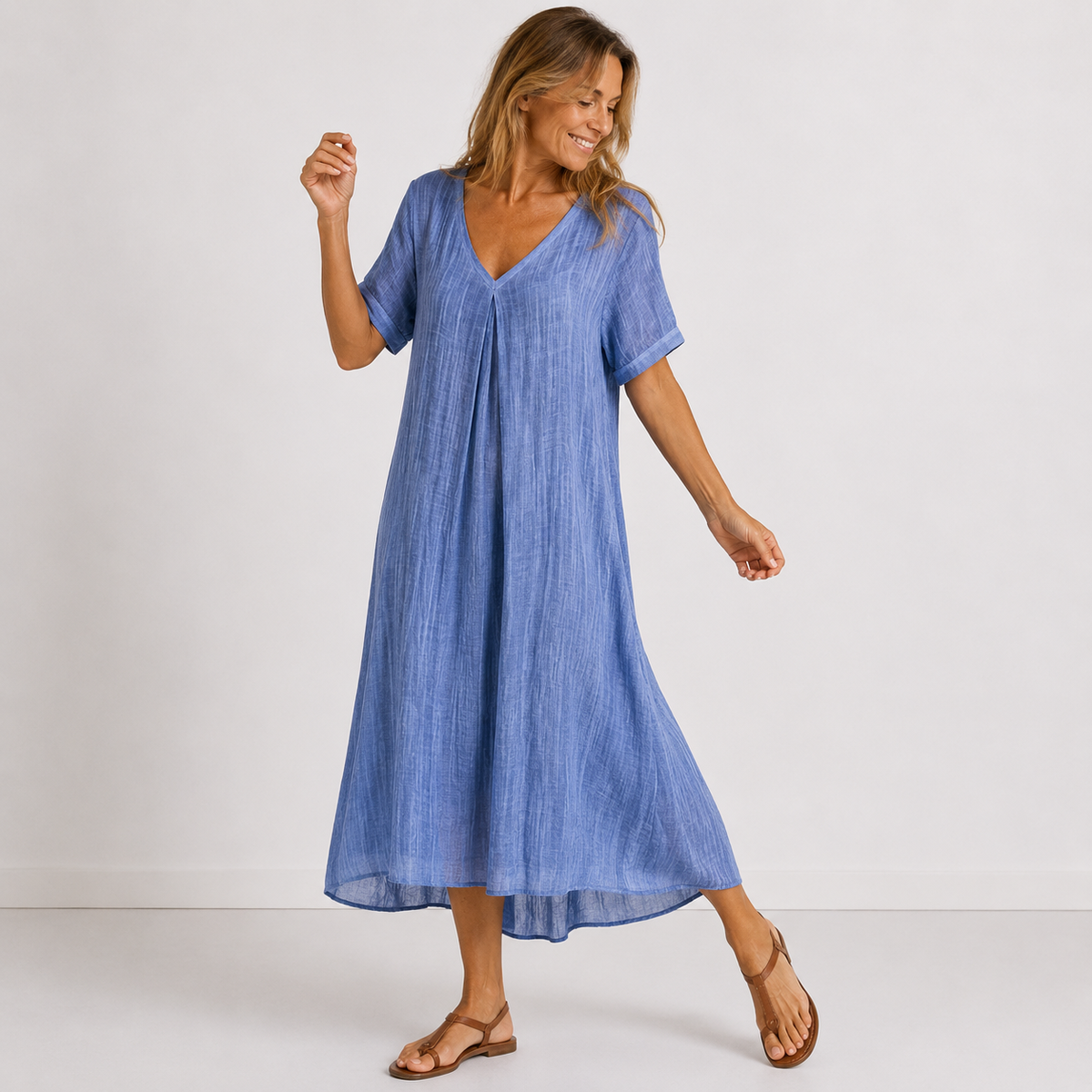 Blue V-neck midi dress with short sleeves, relaxed A-line silhouette and mid-calf length
