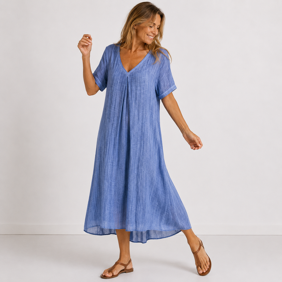 Blue V-neck midi dress with short sleeves, relaxed A-line silhouette and mid-calf length