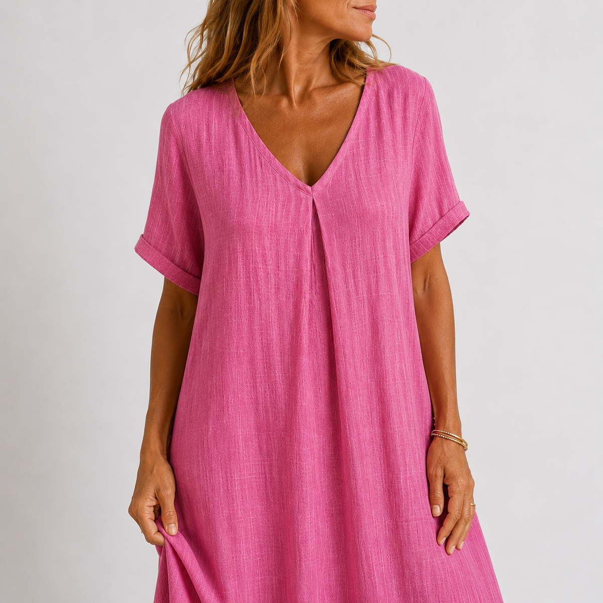 Pink V-neck midi dress close-up with short sleeves and center button placket