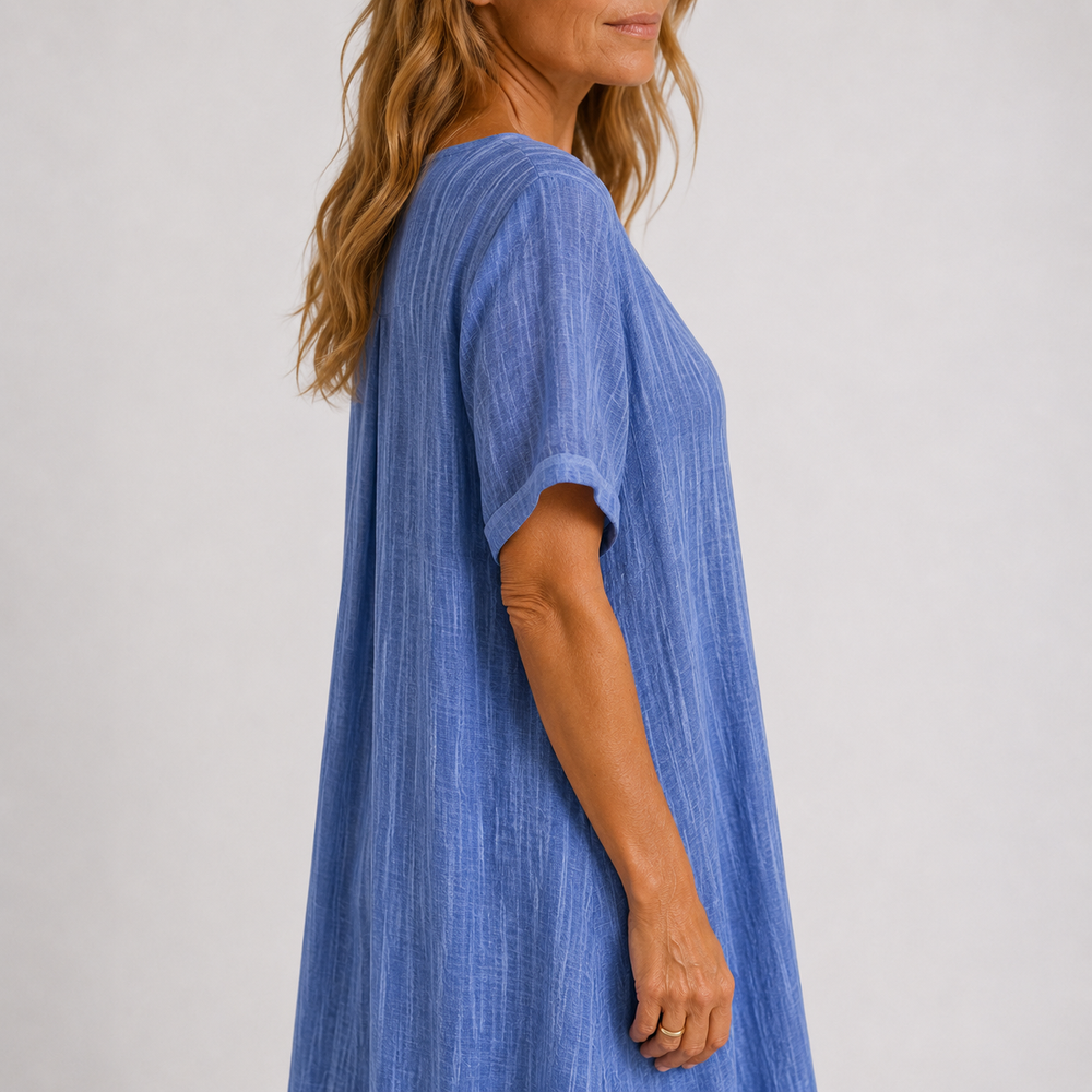 Blue V-neck midi dress side view with short sleeves and flowing A-line skirt