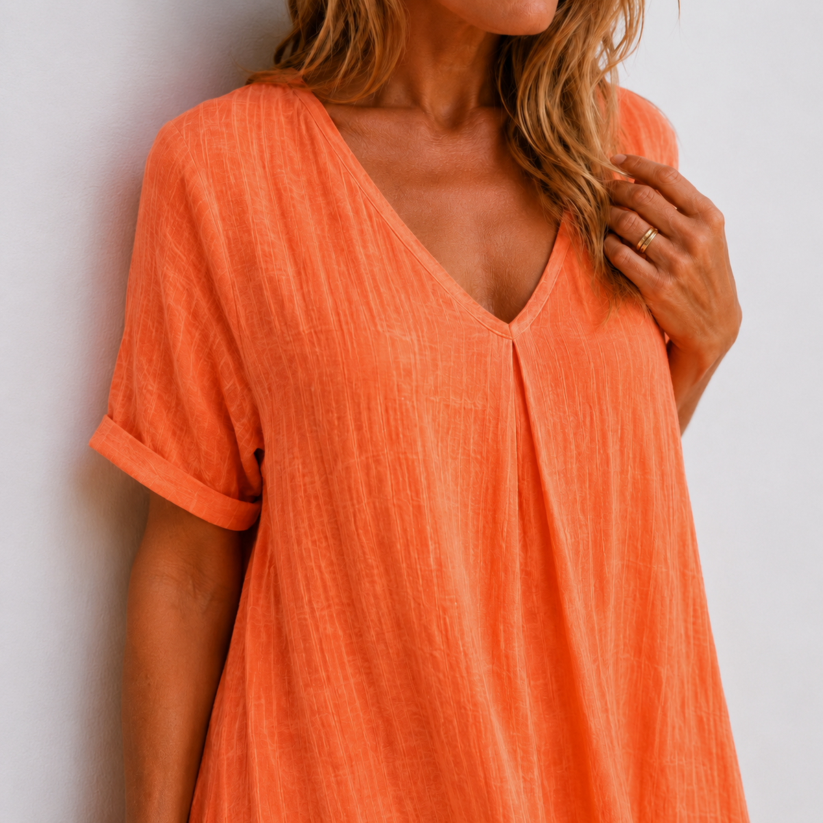 Orange V-neck midi dress close-up, short sleeves and V-neck front seam detail
