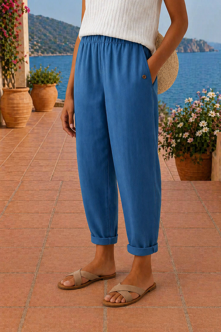 Blue jogger pants with button front and cuffed ankle hems