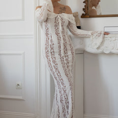 White lace maxi dress with off-shoulder neckline, long sleeves, and vertical lace detailing.