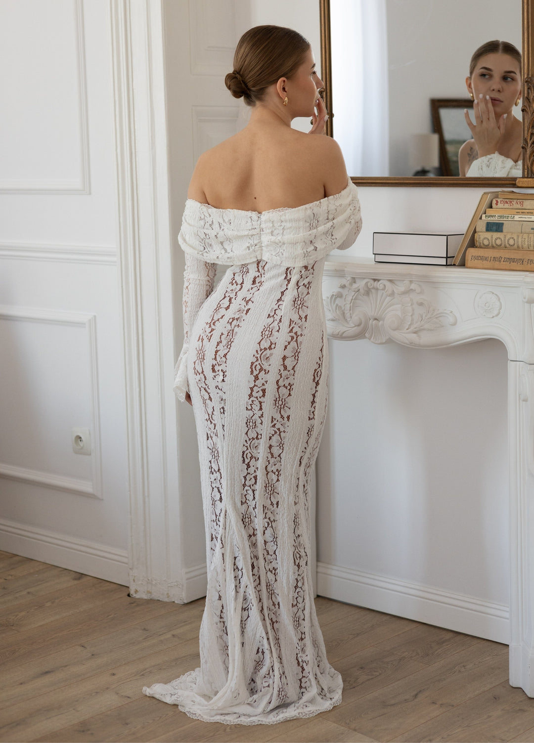 White lace maxi dress, off-shoulder neckline with long sleeves; open back detail.