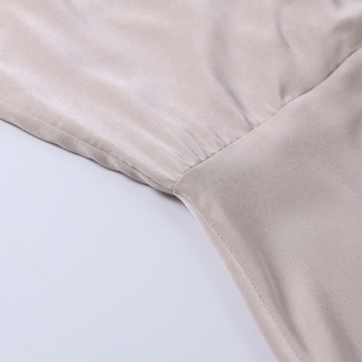 Beige dress fabric close-up with side seam and smooth cowl neckline