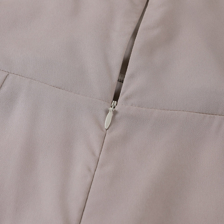 Beige sleeveless dress with visible zipper seam at back