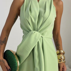 Light green halter cowl-neck jumpsuit with tied waist and wide-leg pants