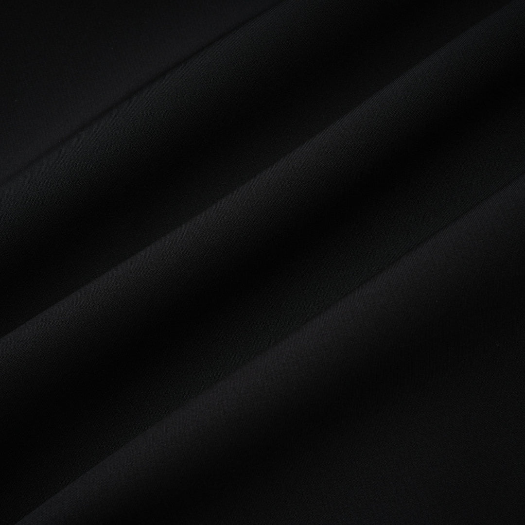 Black fabric close-up showing smooth, even texture with subtle sheen