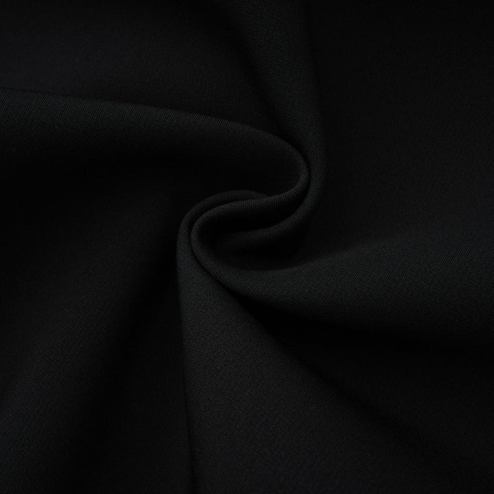 Black fabric close-up with gathered folds and fine woven texture