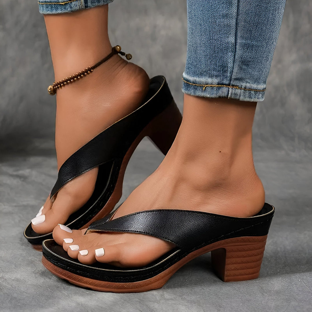 Women’s high-heeled mule sandals in black with wide toe strap and mid-height chunky heel
