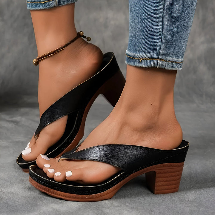 Women’s high-heeled mule sandals in black with wide toe strap and mid-height chunky heel
