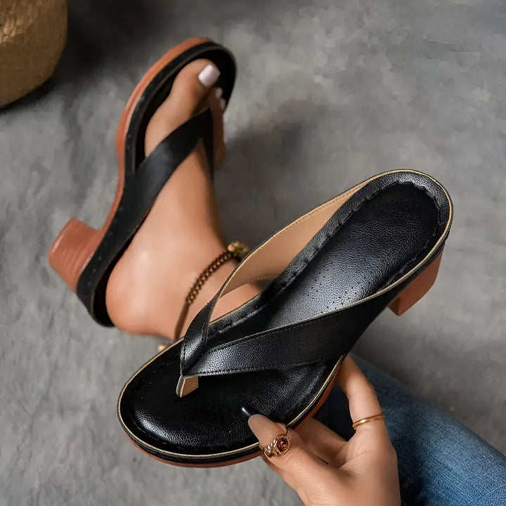 Women’s high-heeled mule sandals in black leather-look with crisscross front strap and block heel